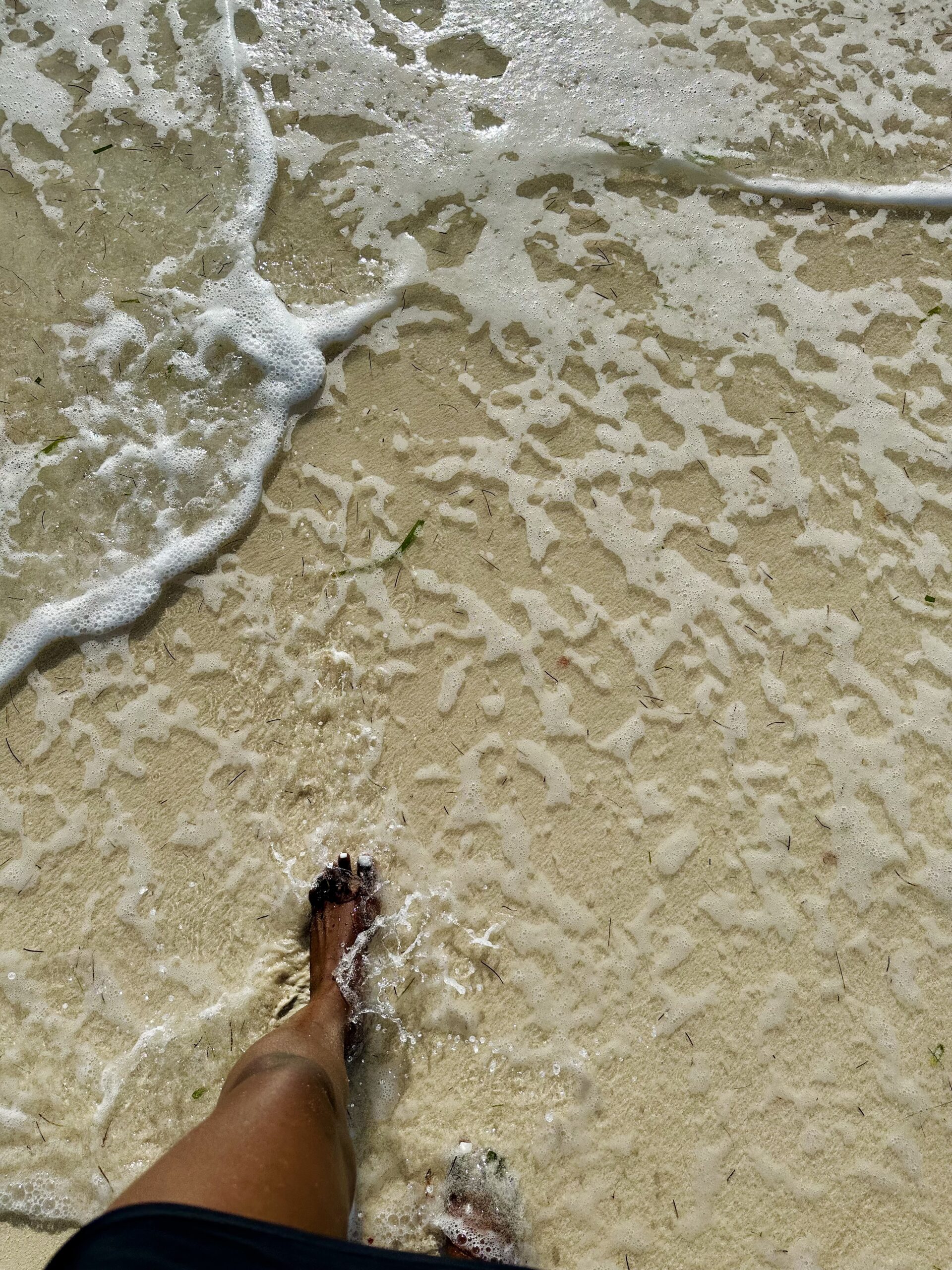 Feet on shoreline