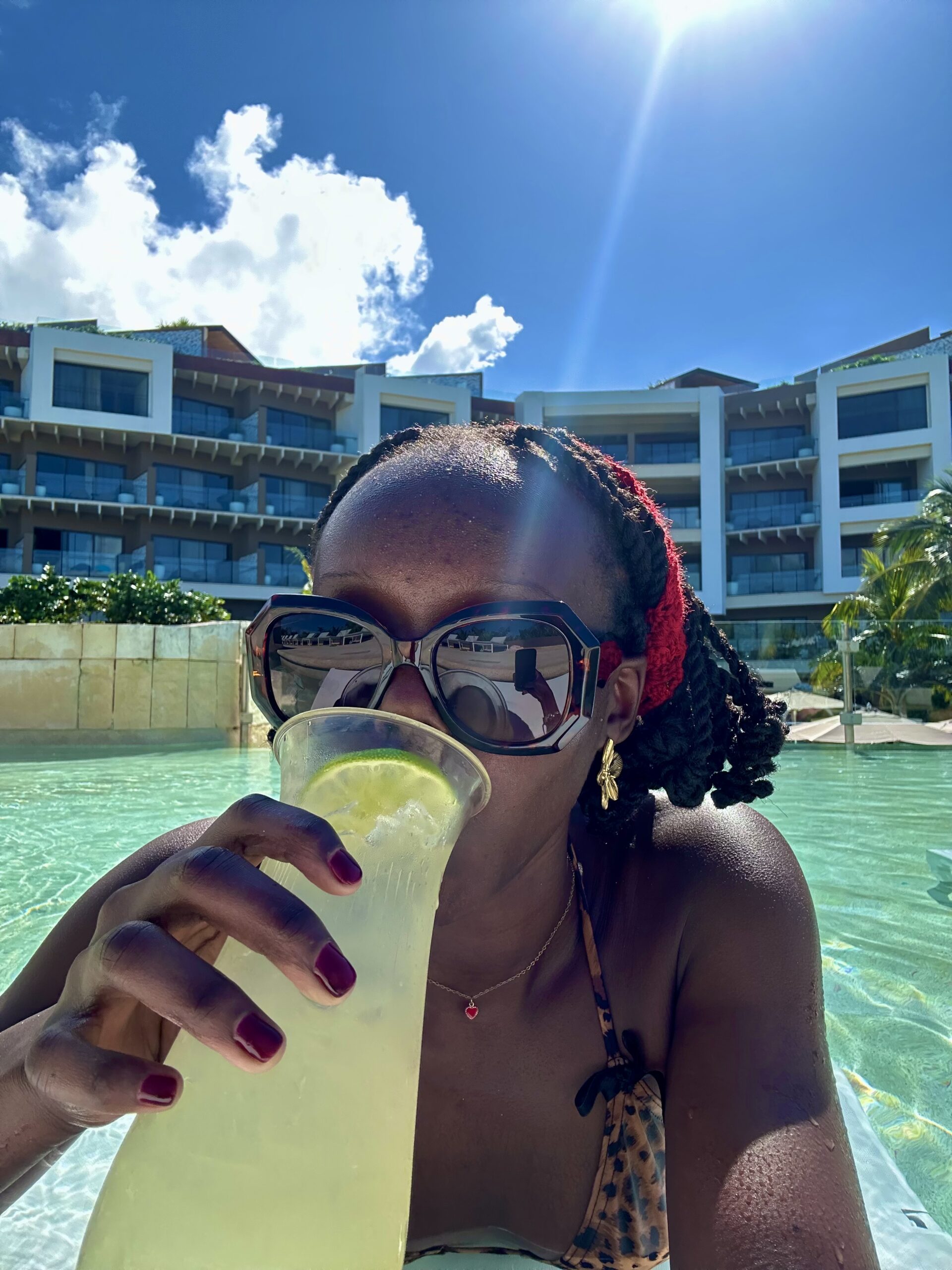 Author drinking lemonade in pool