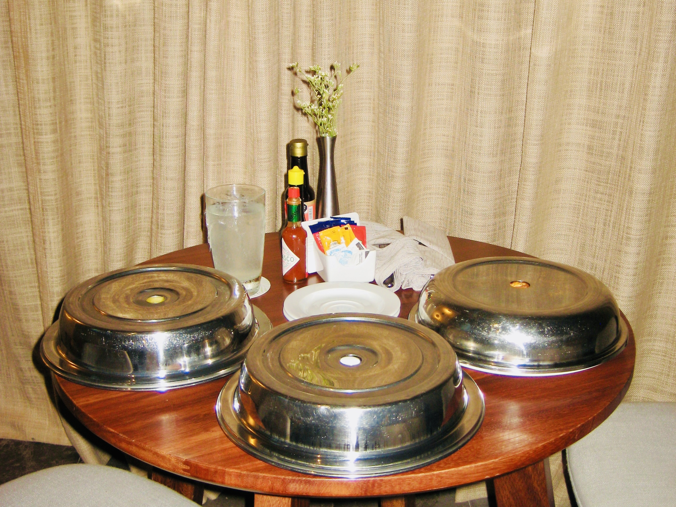 Room service trays with food on table