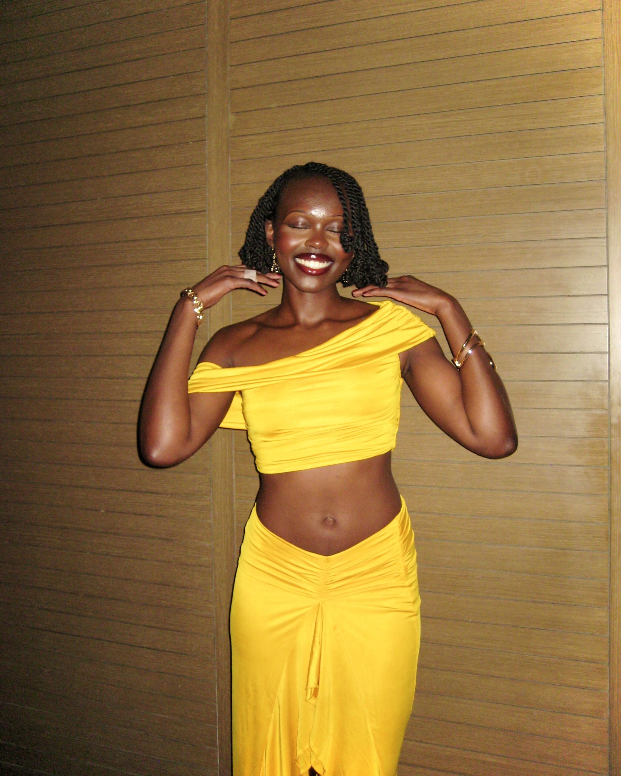 Author posing in yellow two-piece